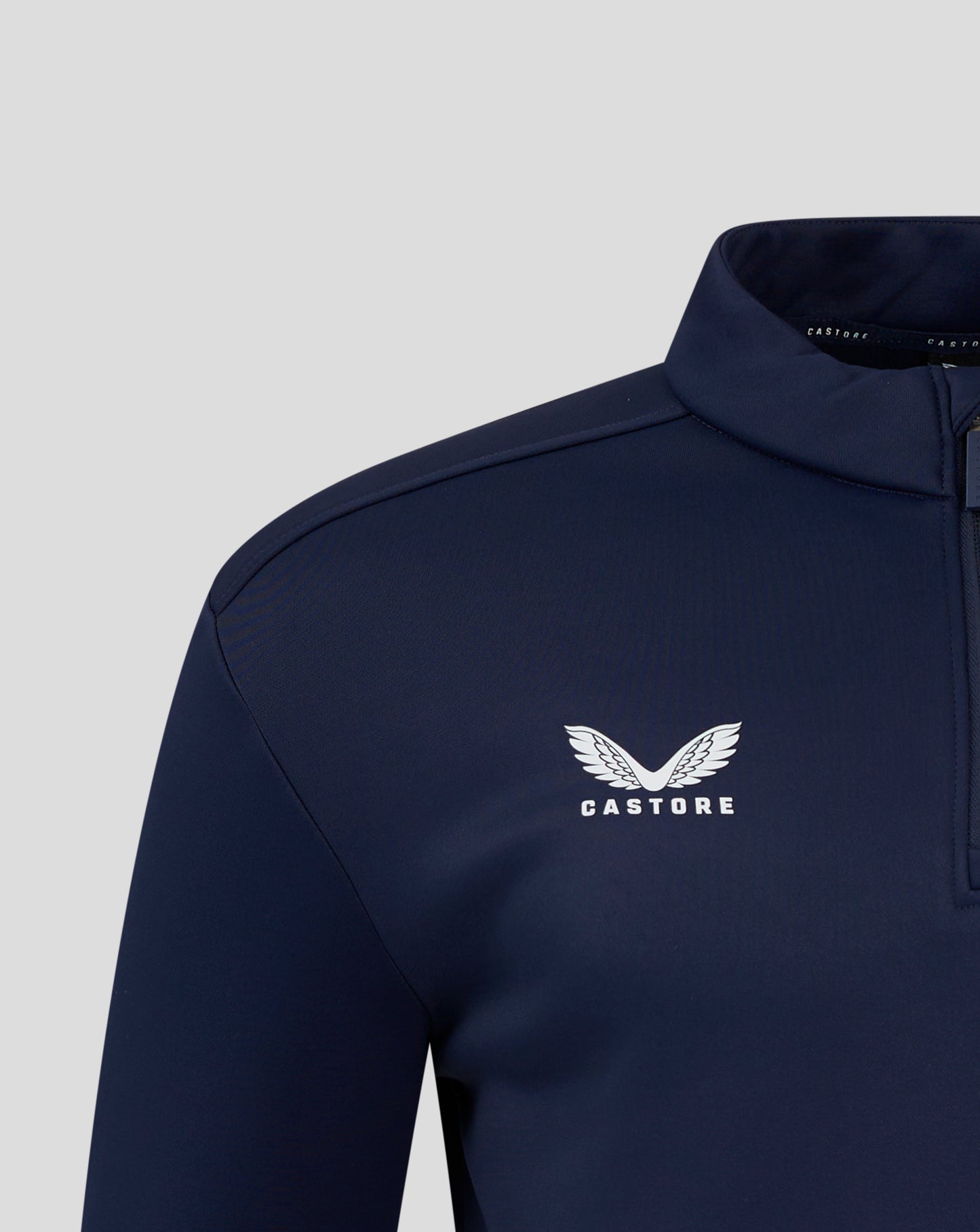 Rear shoulder and upper back of navy fleece pullover with clean seam lines