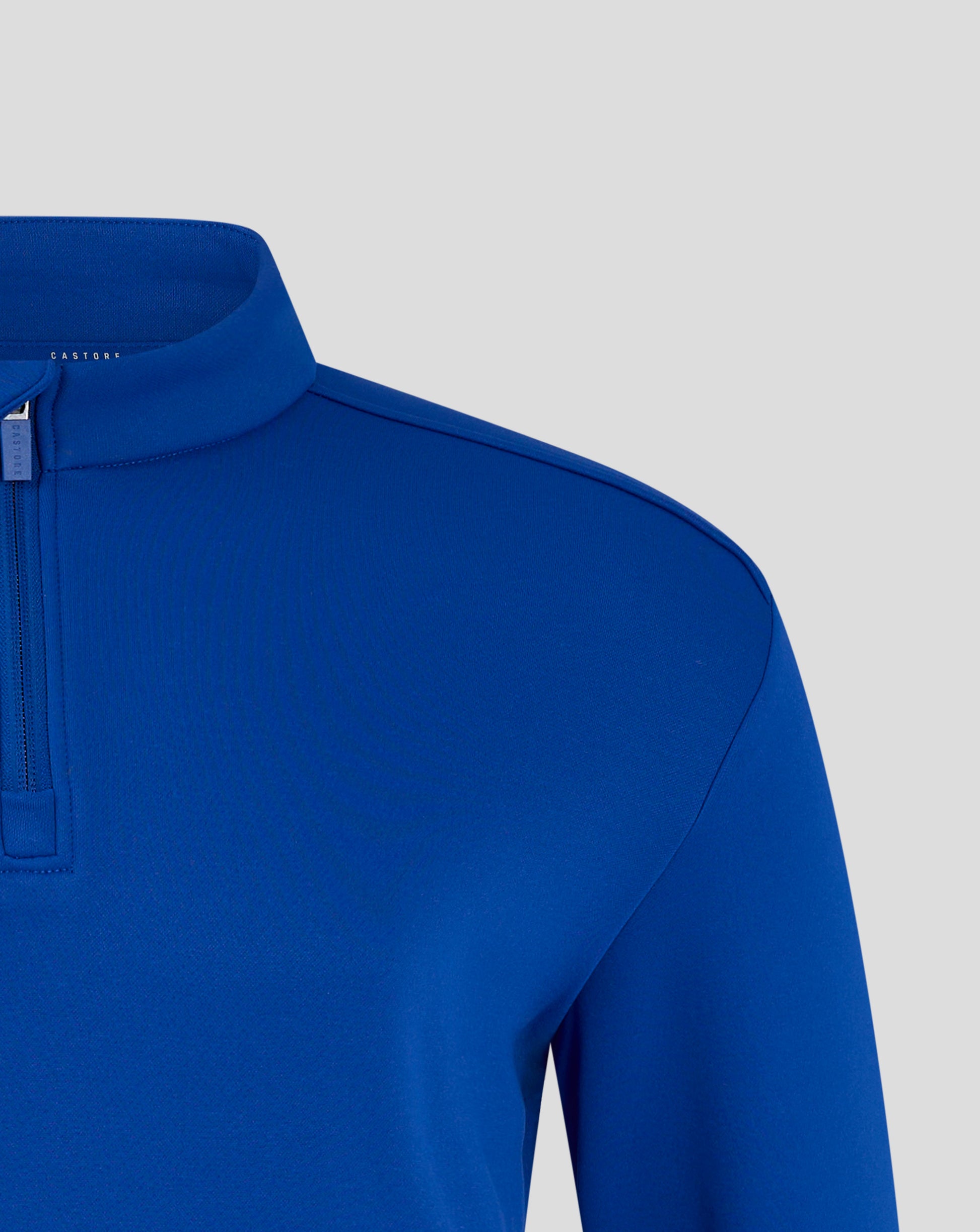 Blue fleece jacket collar and shoulder detail with a zipper pull and Castore branding