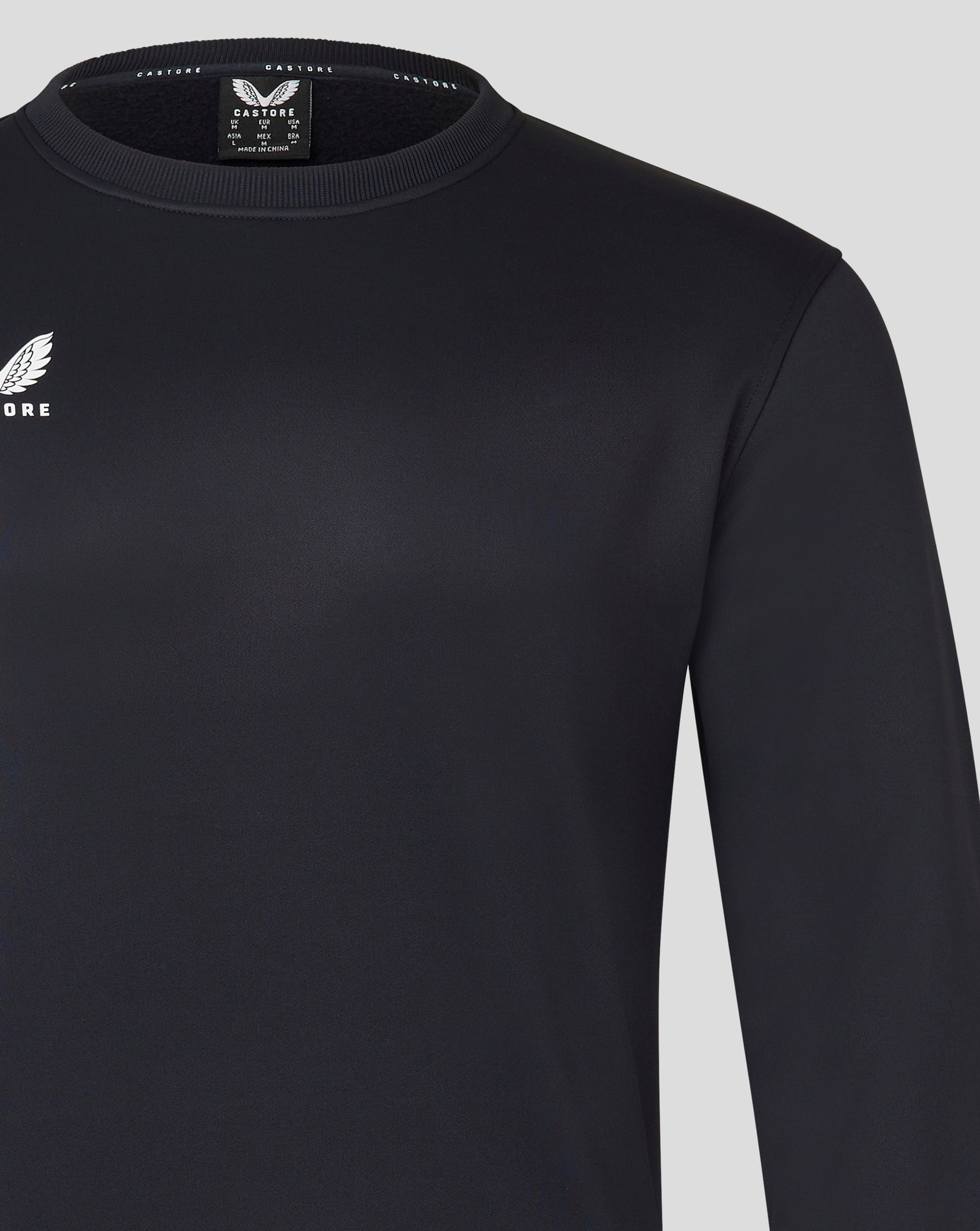 Close up of Mens Brushback Sweatshirt in Caviar showing ribbed crew neck and Castore logo on chest