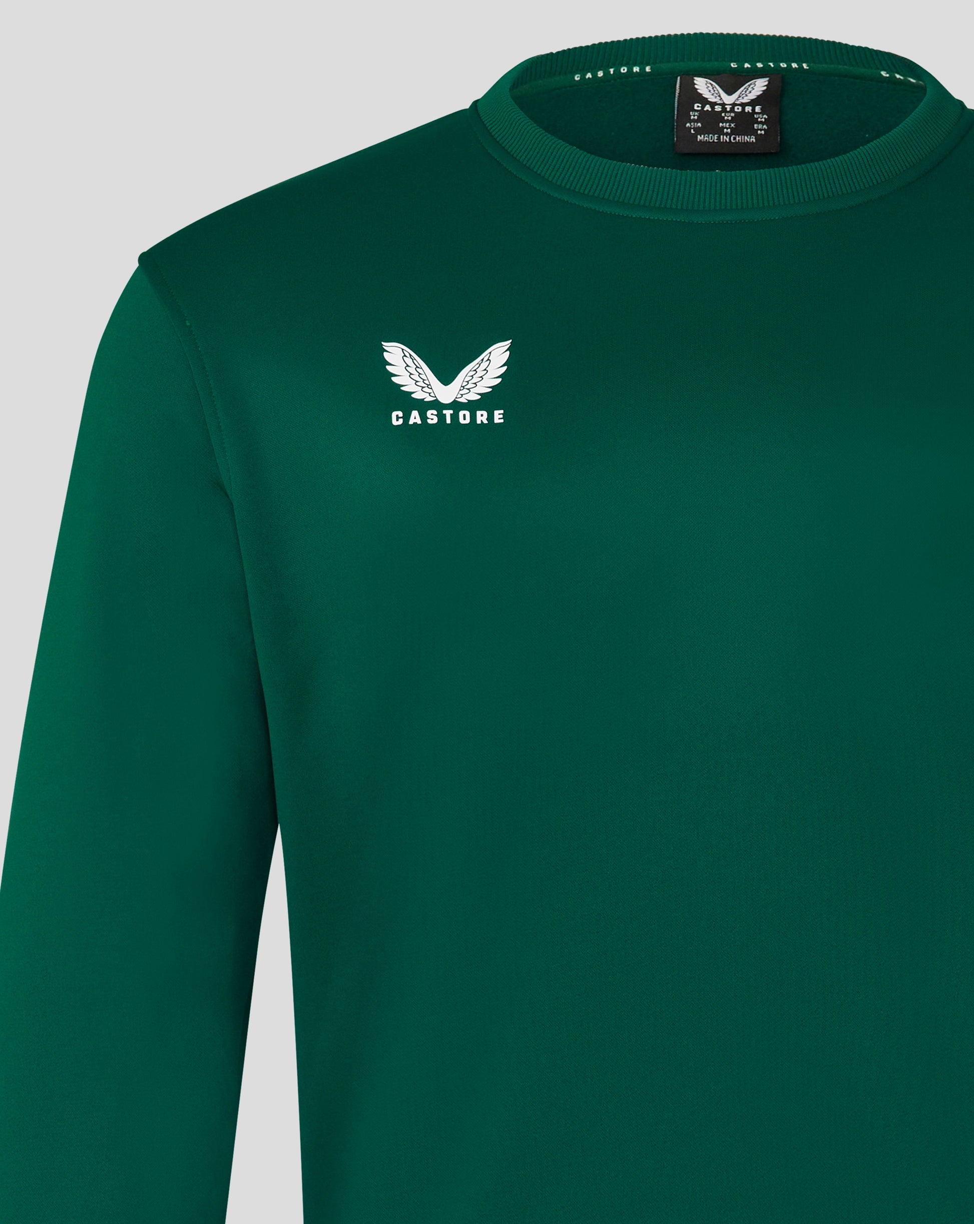 Close up of the green brushback sweatshirt showing the left chest Castore logo and ribbed neckline