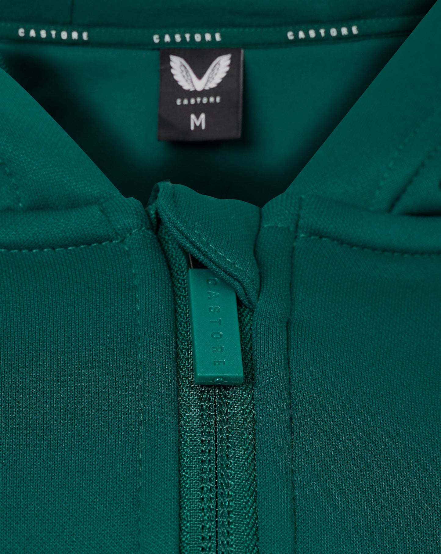 Teal green hoodie close up showing front zipper and Castore logo on chest