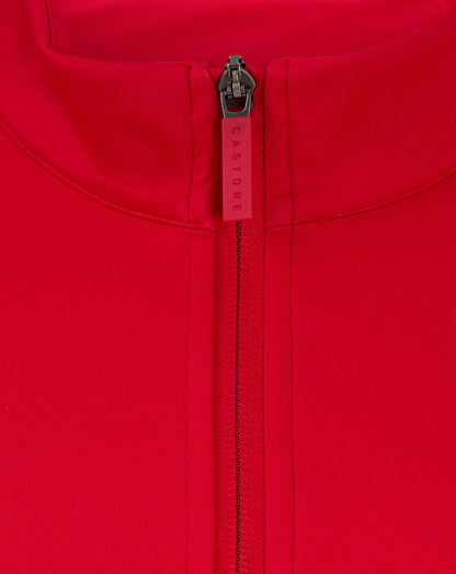 Close up of a red jacket zipper at the collar with Castore branding on the zipper pull