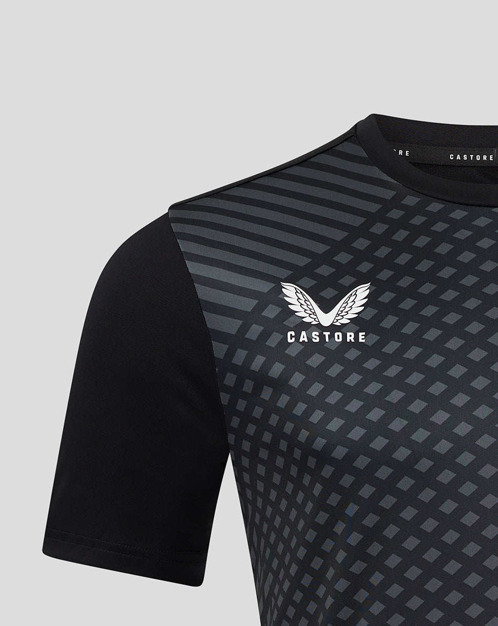 Close up of shoulder and chest on the black geometric training T shirt showing the print and Castore logo
