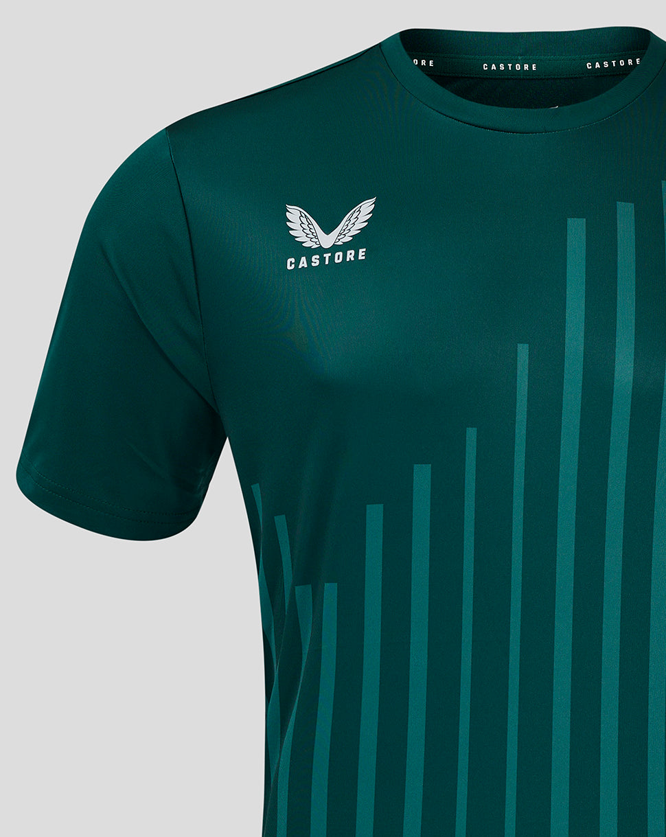 Close up of the left chest on a dark green training tee showing the white Castore logo and teal stripe motif