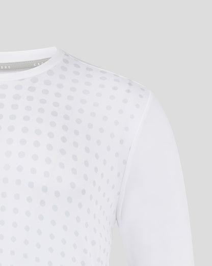 White training tee with an allover light gray dot pattern shown up close.