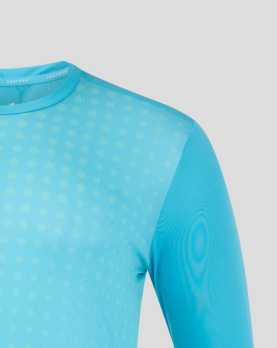 Close up of shoulder and neckline on aquamarine Castore long sleeve training shirt with dotted print.