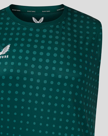 Shoulder and upper chest view of teal dotted singlet with Castore branding along neckline