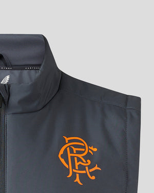 Close up of navy Rangers bench gilet chest with orange club crest on the left and Castore branding on the right.