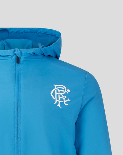 Blue lightweight training jacket front view with hood, full zipper, left chest club crest and right chest Castore branding