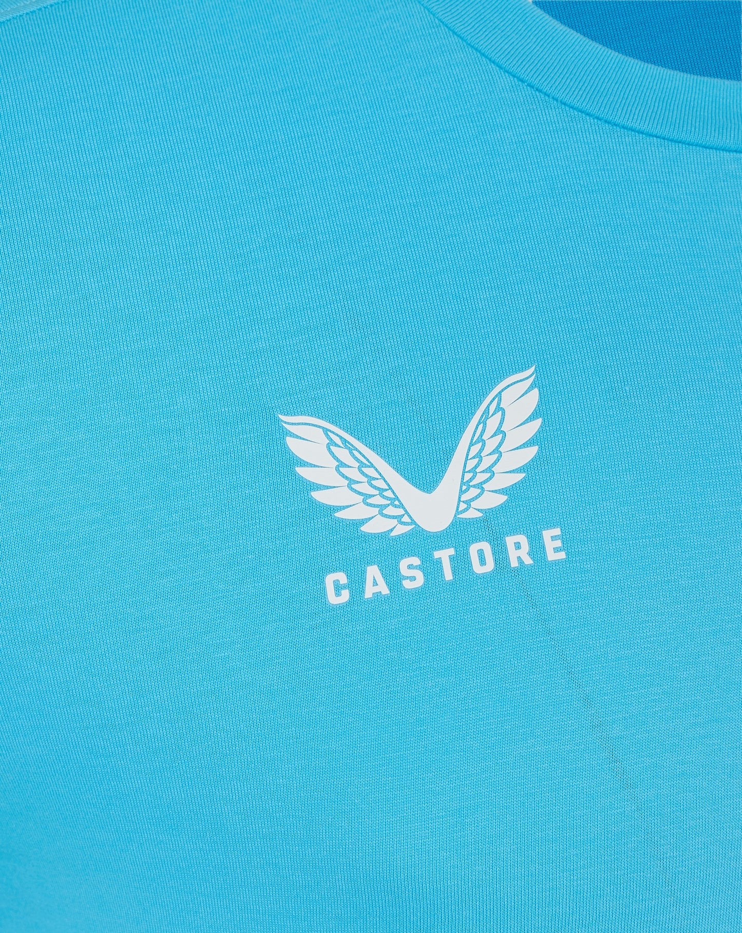 Back view of turquoise Castore Aquarius tee with smooth fabric and curved neckline