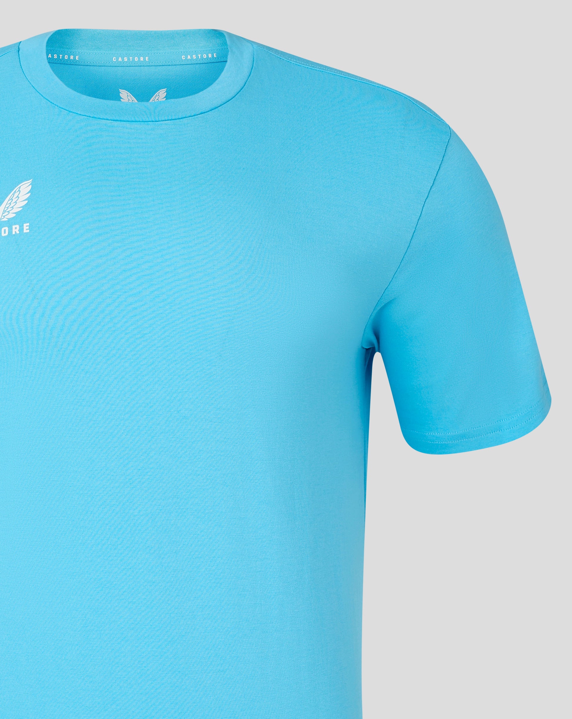 Blue crew neck tee with inner label along collar and small white Castore logo on the left chest