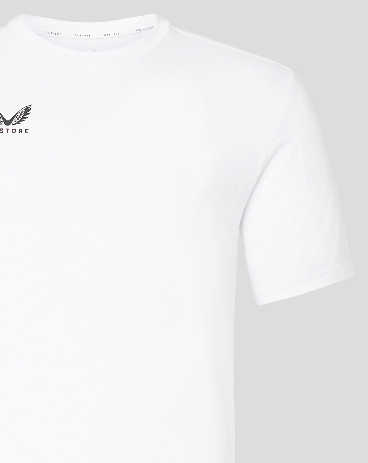 Close up of white Castore tee showing crew neck and branded inner collar tape
