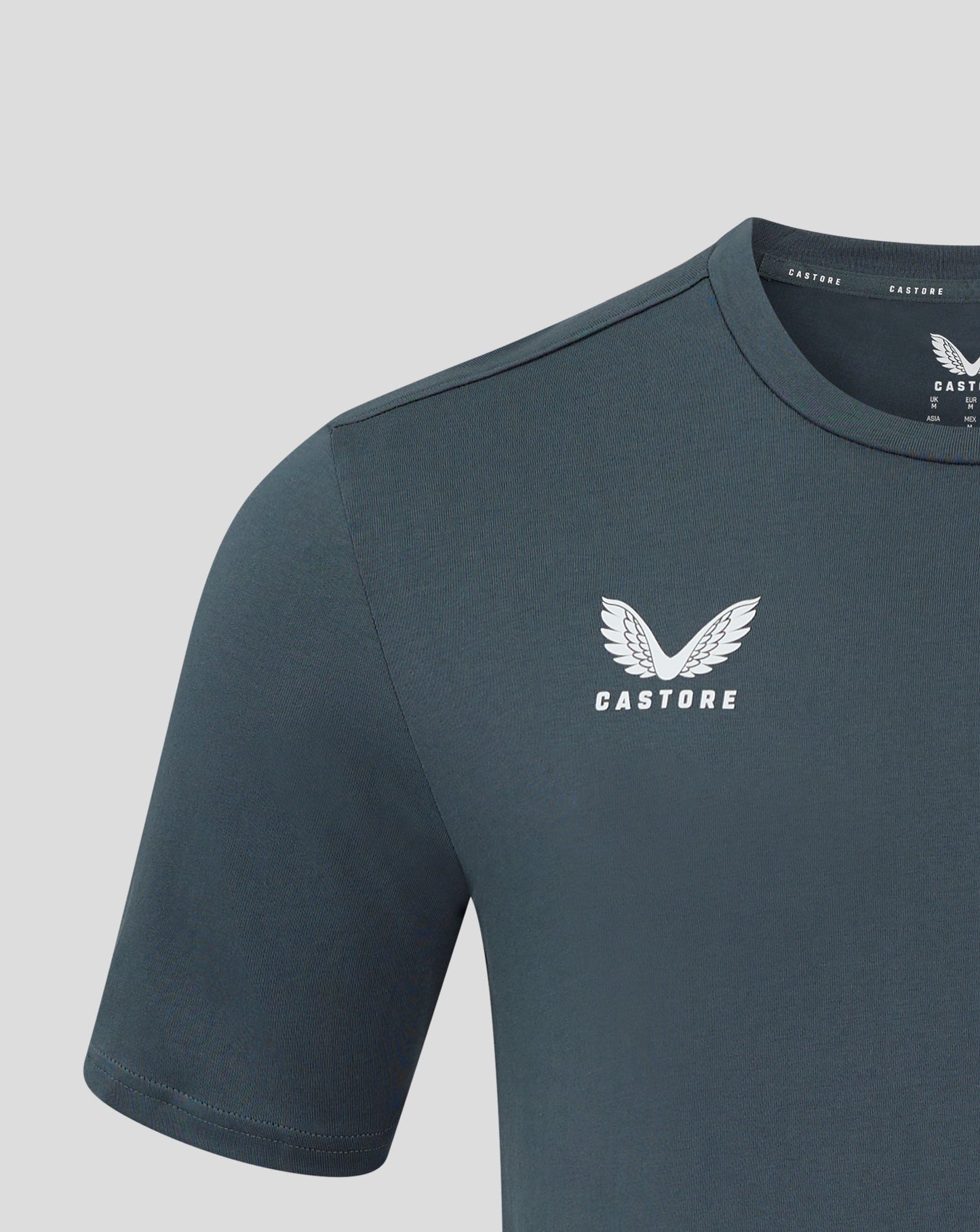 Dark slate men's cotton leisure tee close up of crew neck and shoulder seam with Castore logo on chest