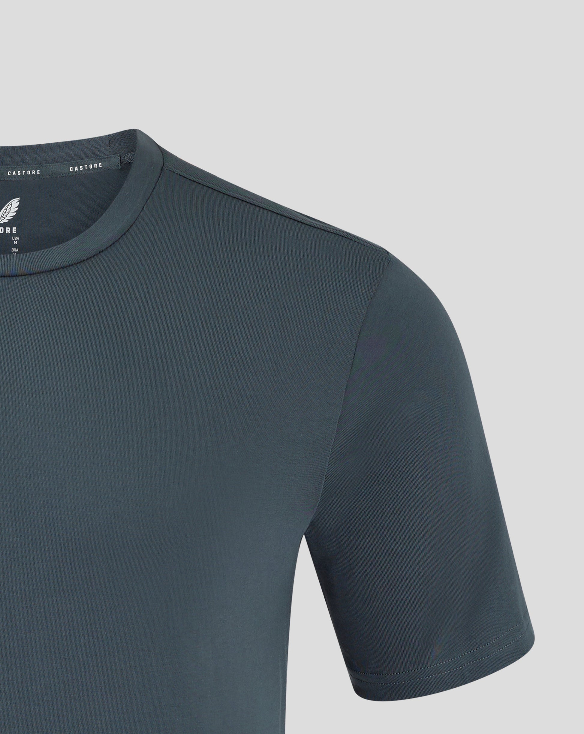 Dark slate leisure tee shown from front with visible Castore branding on neck tape