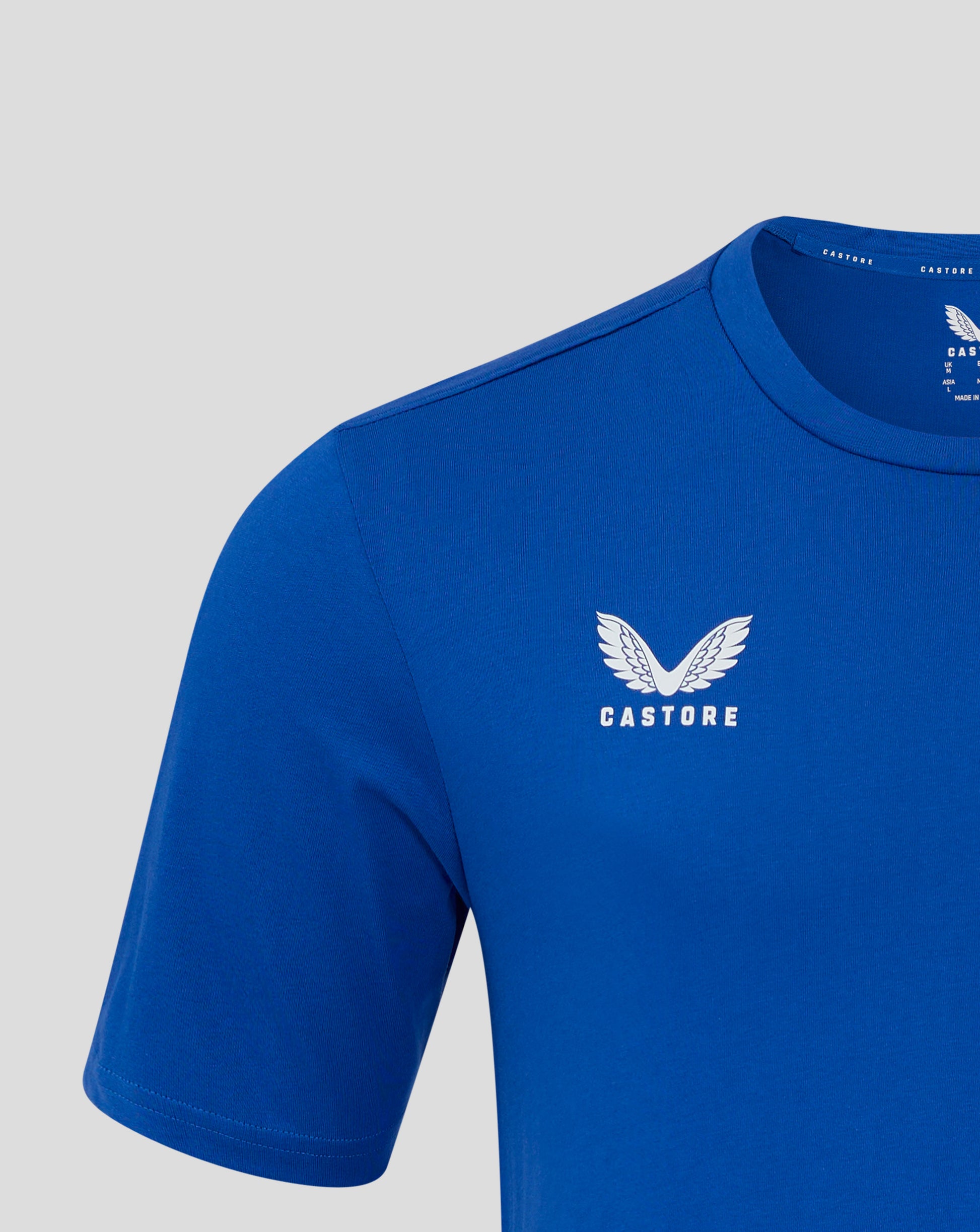 Close up of the blue mens cotton leisure tee neckline showing self fabric collar and Castore branding