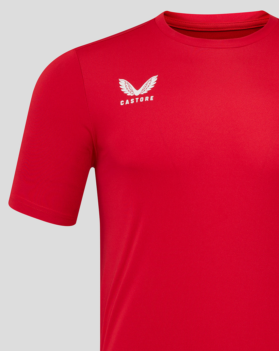 Close up of the left chest area showing a white wing logo on the Barbados Cherry red training tee.
