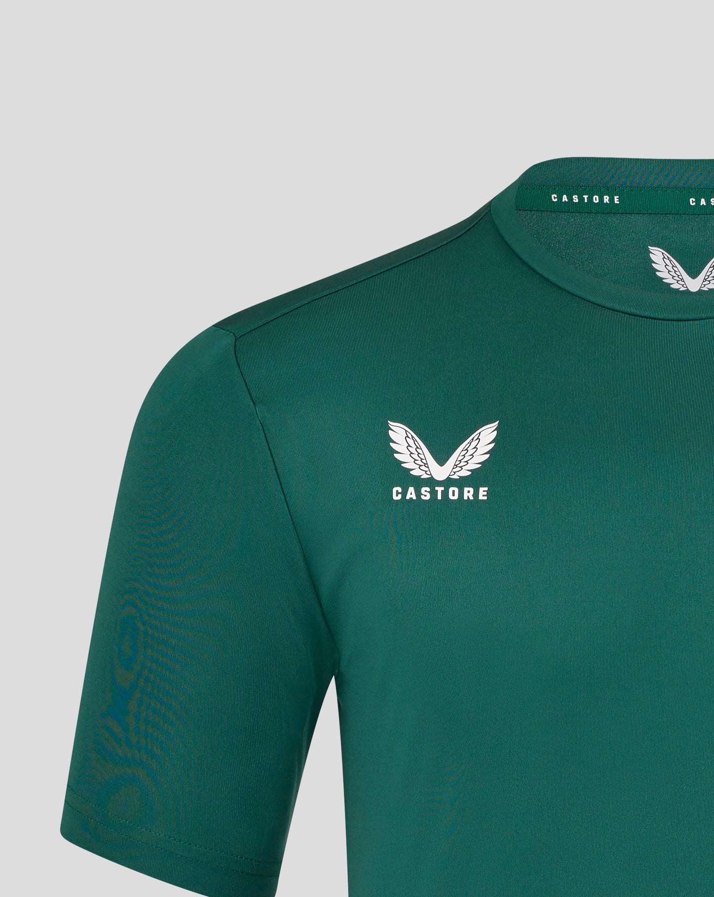 Close up of green Leicester Tigers training T shirt showing white wing crest and Castore branding on the collar