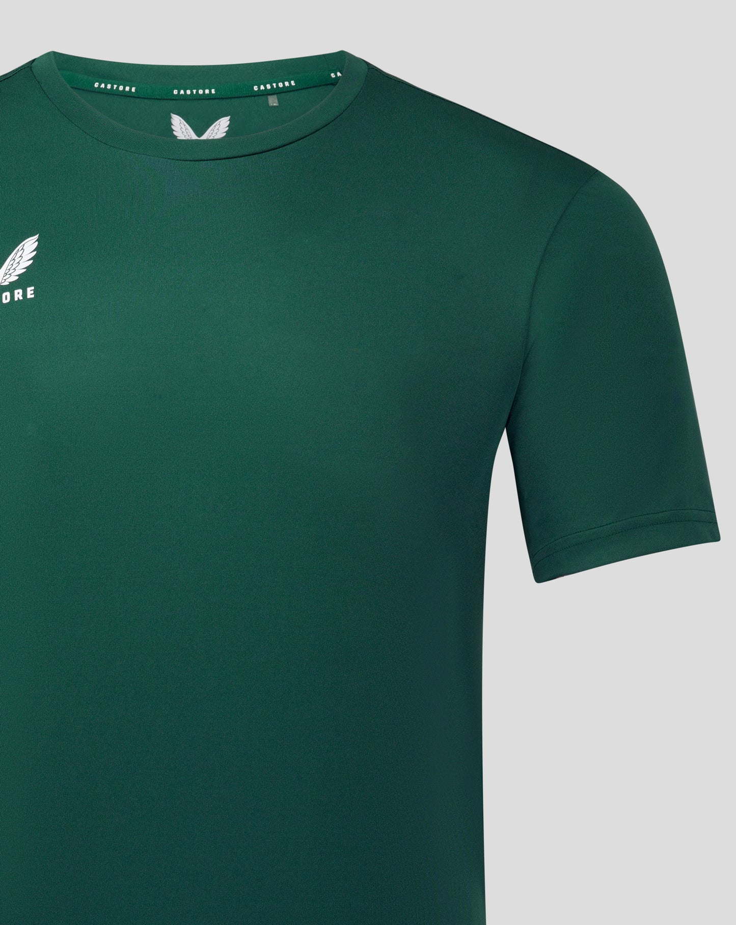 Front view of forest green performance tee with white Castore logo on the left chest.