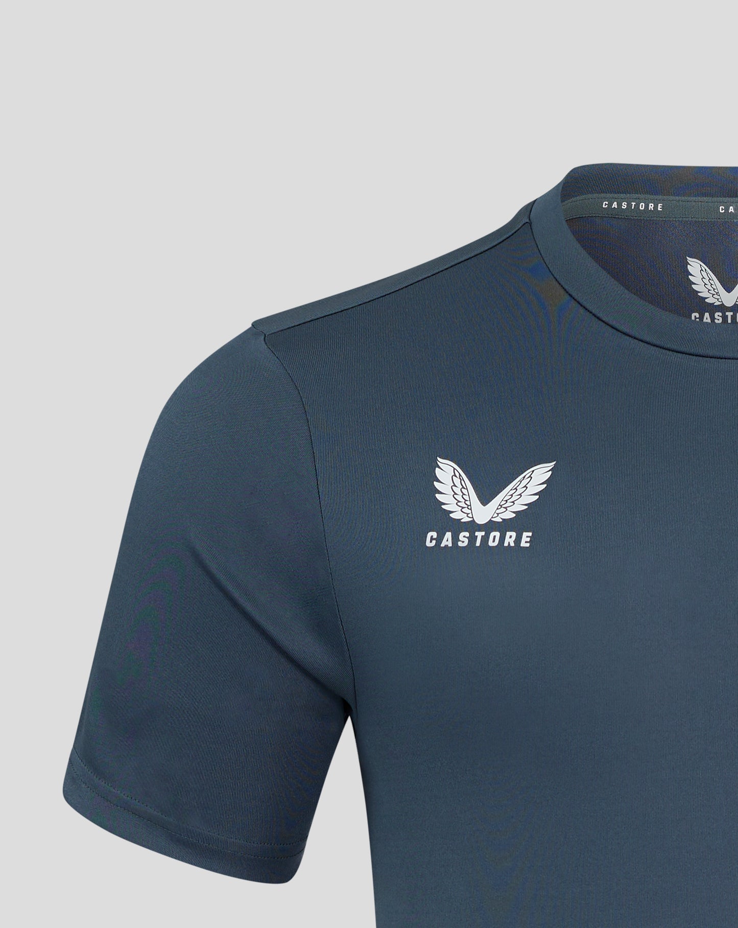 Close up of neck and shoulder on dark slate tee with Castore branding along the collar