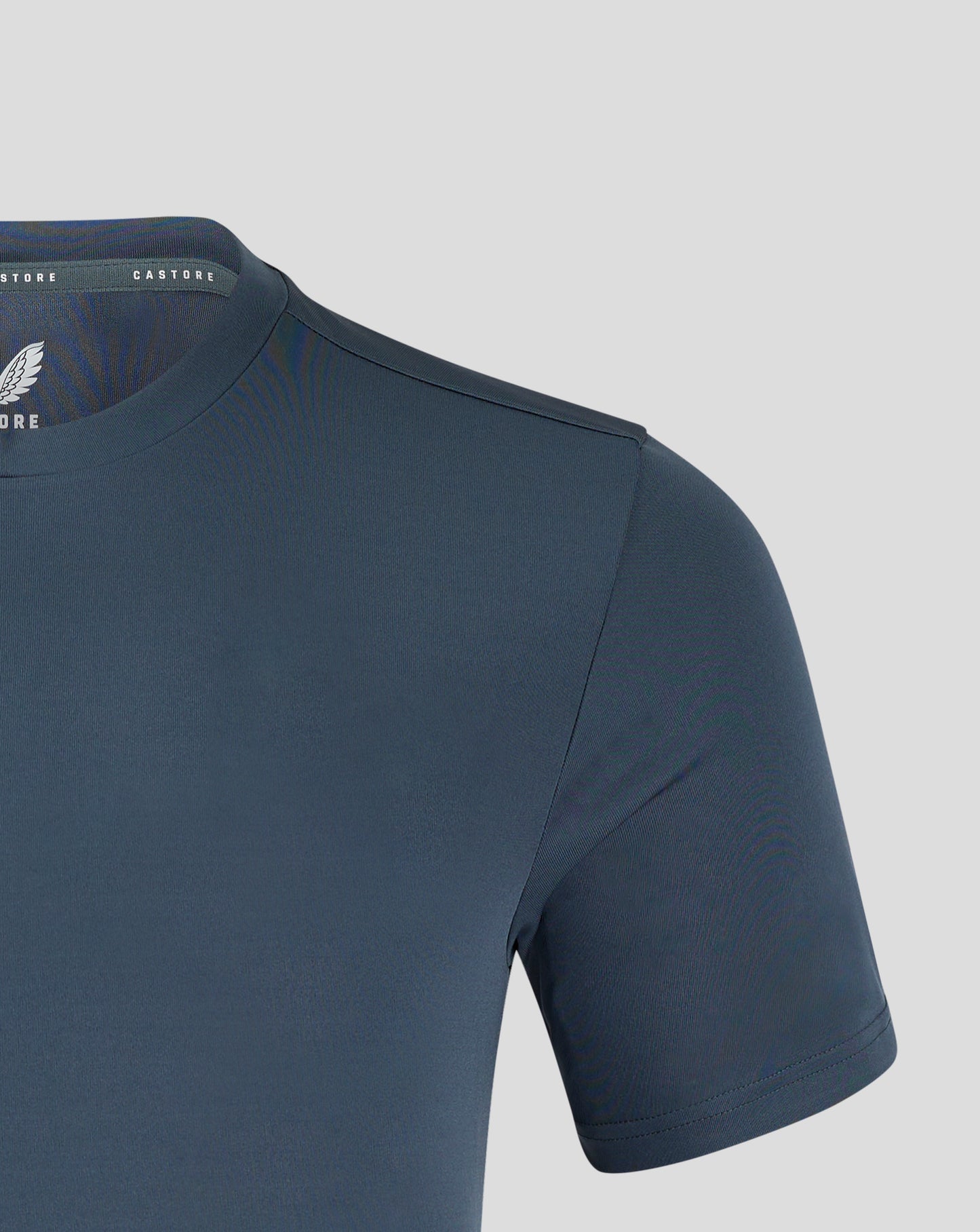 Front chest of dark slate tee featuring white Castore crest and branding