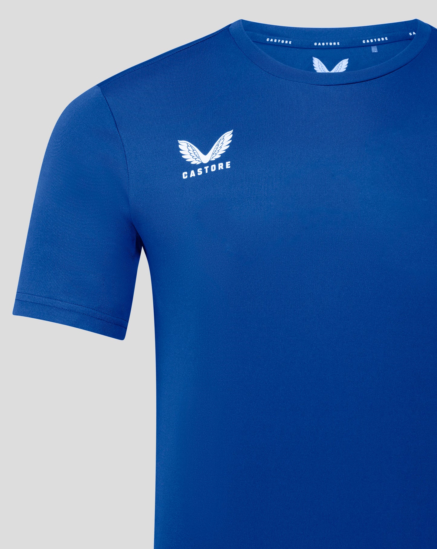 Blue Castore performance tee with large white wing logo on left chest and short sleeve