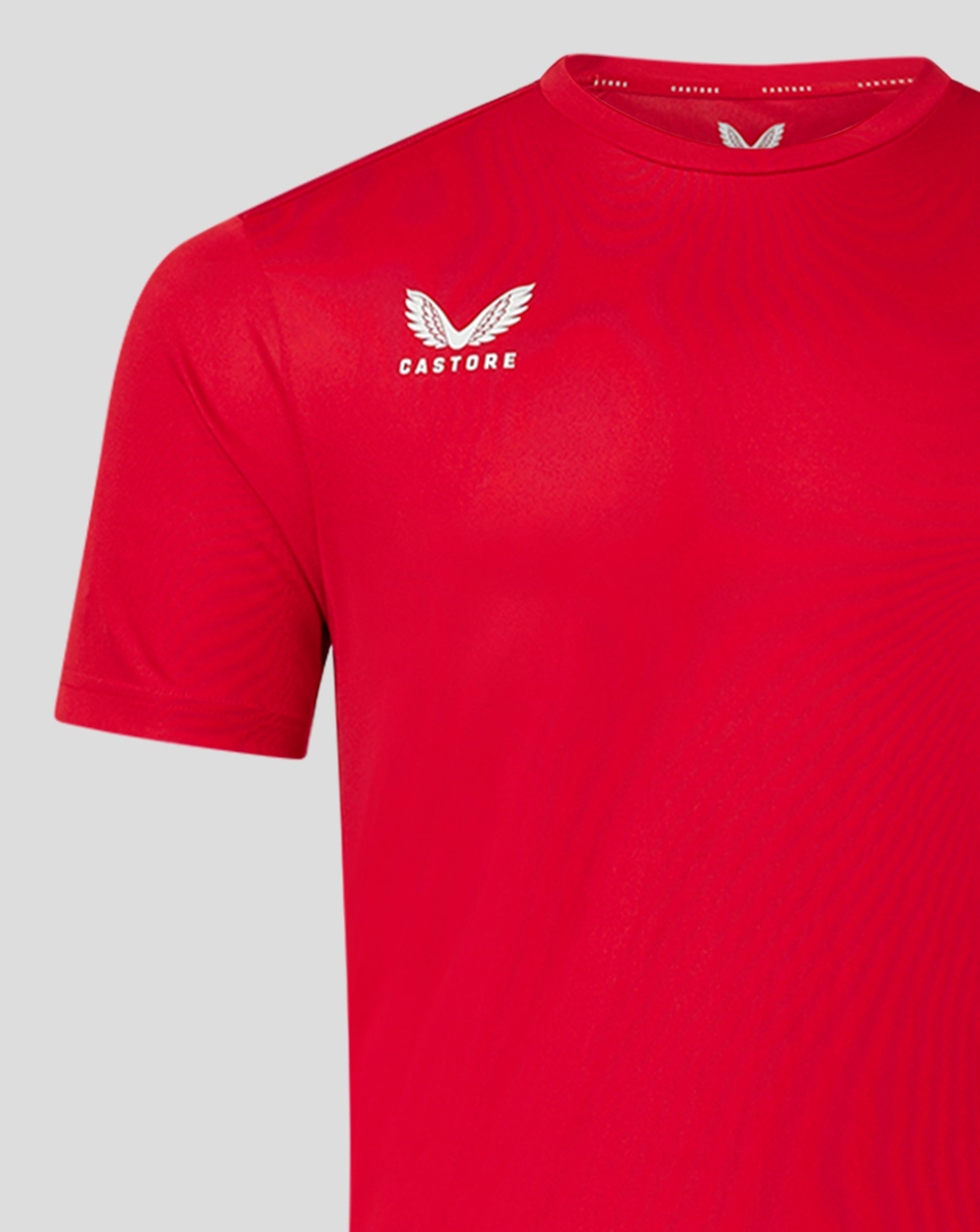 Front view of red men's performance tee featuring the white Castore logo on the chest
