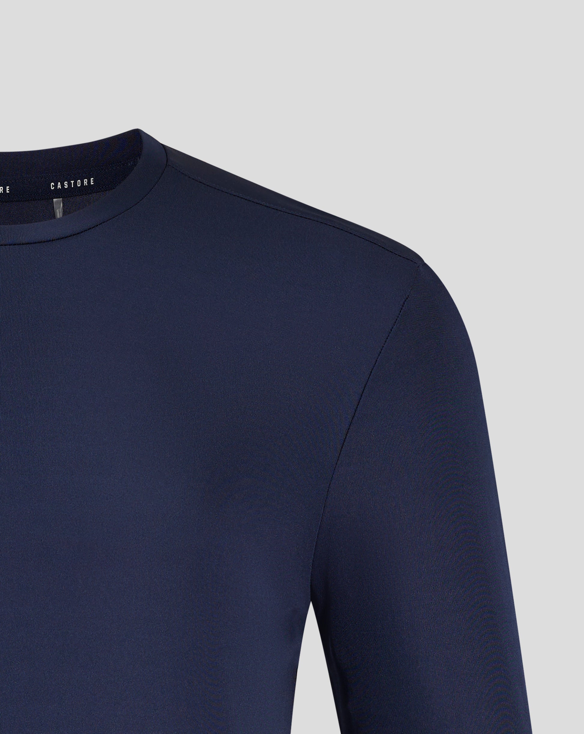Front view of navy Peacoat long sleeve tee displaying Castore crest and logo centered on the chest