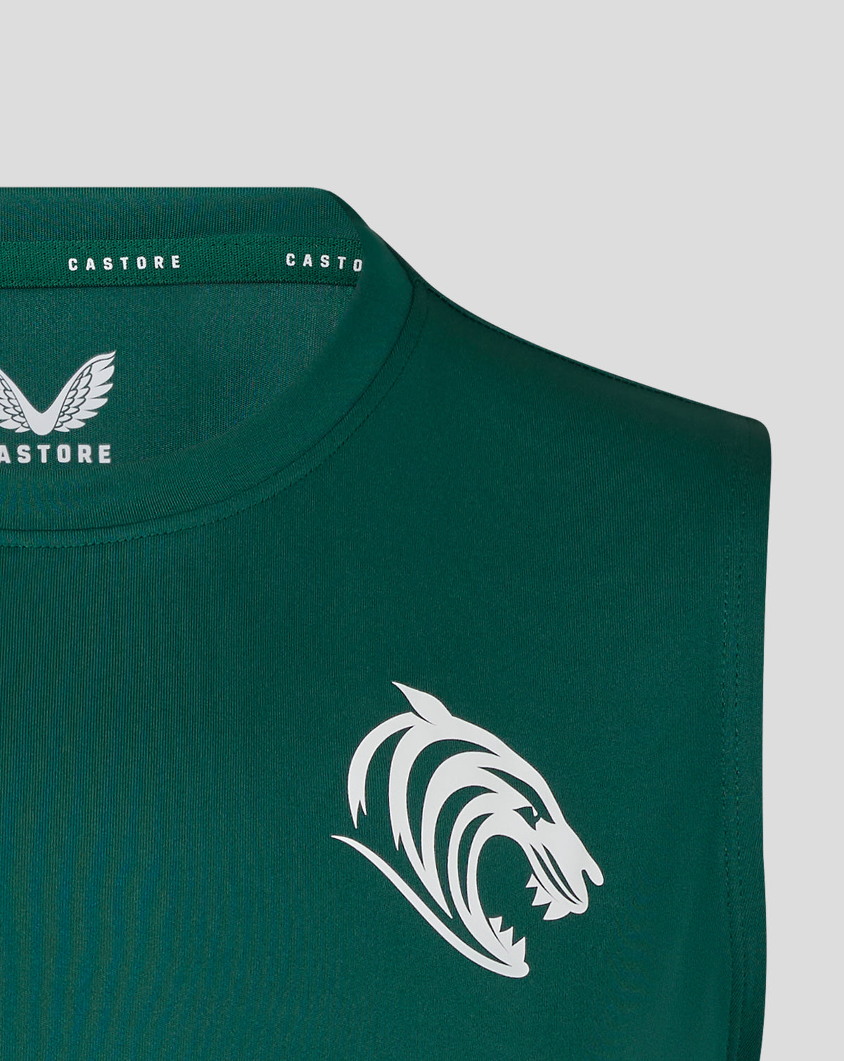 Close-up of botanical green vest neckline showing Castore branding and wing logo