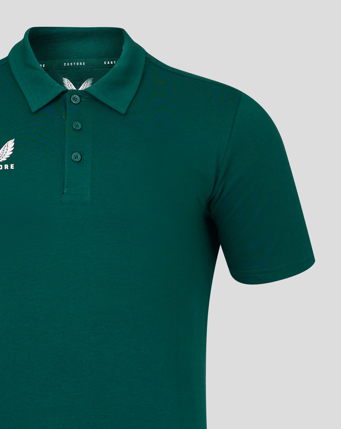 Forest green polo shirt with self fabric collar and three button placket and Castore logo on chest