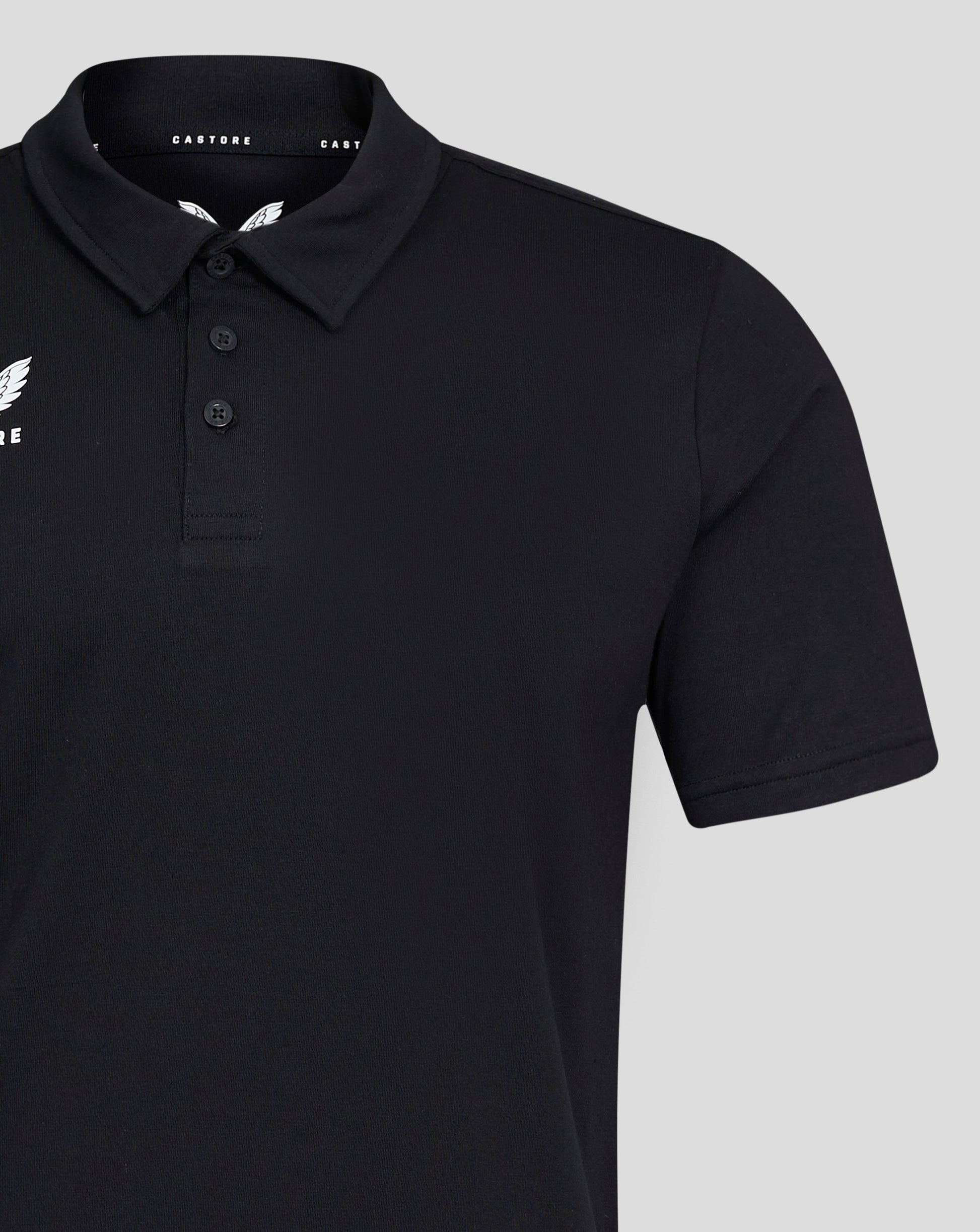 Close up of black Mens Cotton Leisure Polo with self fabric collar three button placket and white Castore logo on chest.