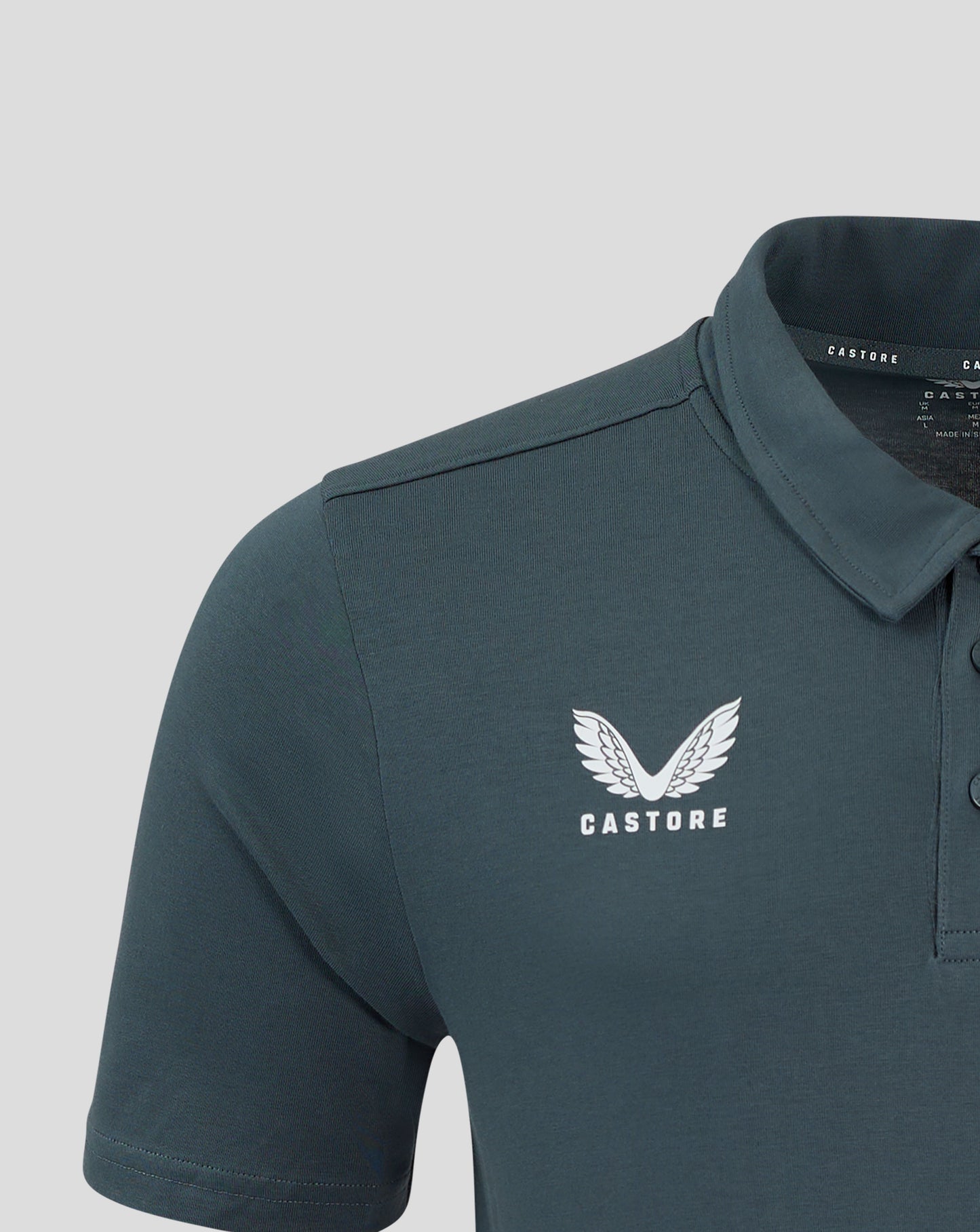 Close up of dark slate polo collar with self fabric collar and three button placket