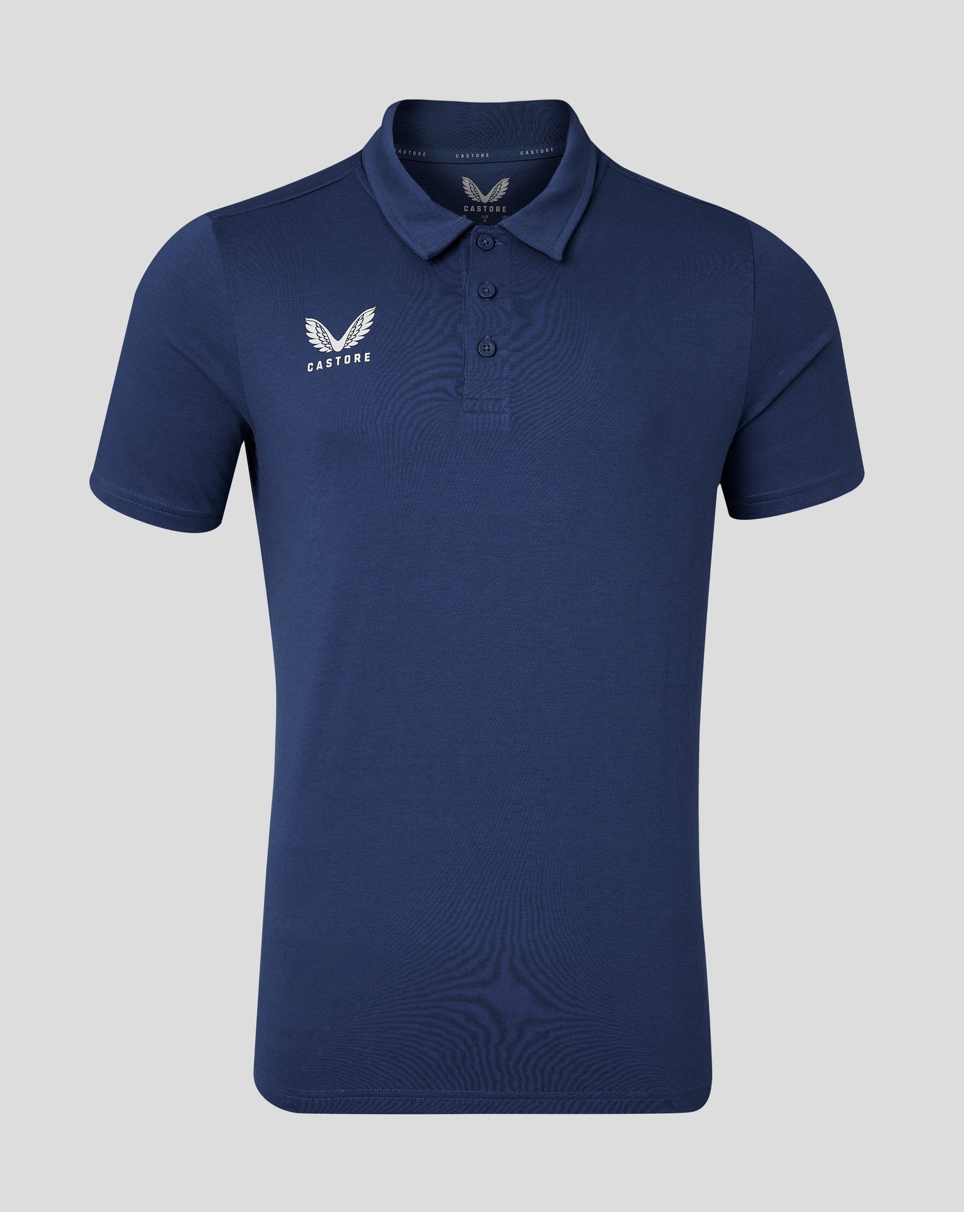 Back view of navy cotton leisure polo with soft collar and forward shoulder seam.