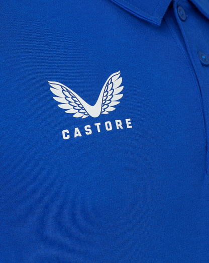 Close-up of white Castore wing logo on blue polo fabric with CASTORE text