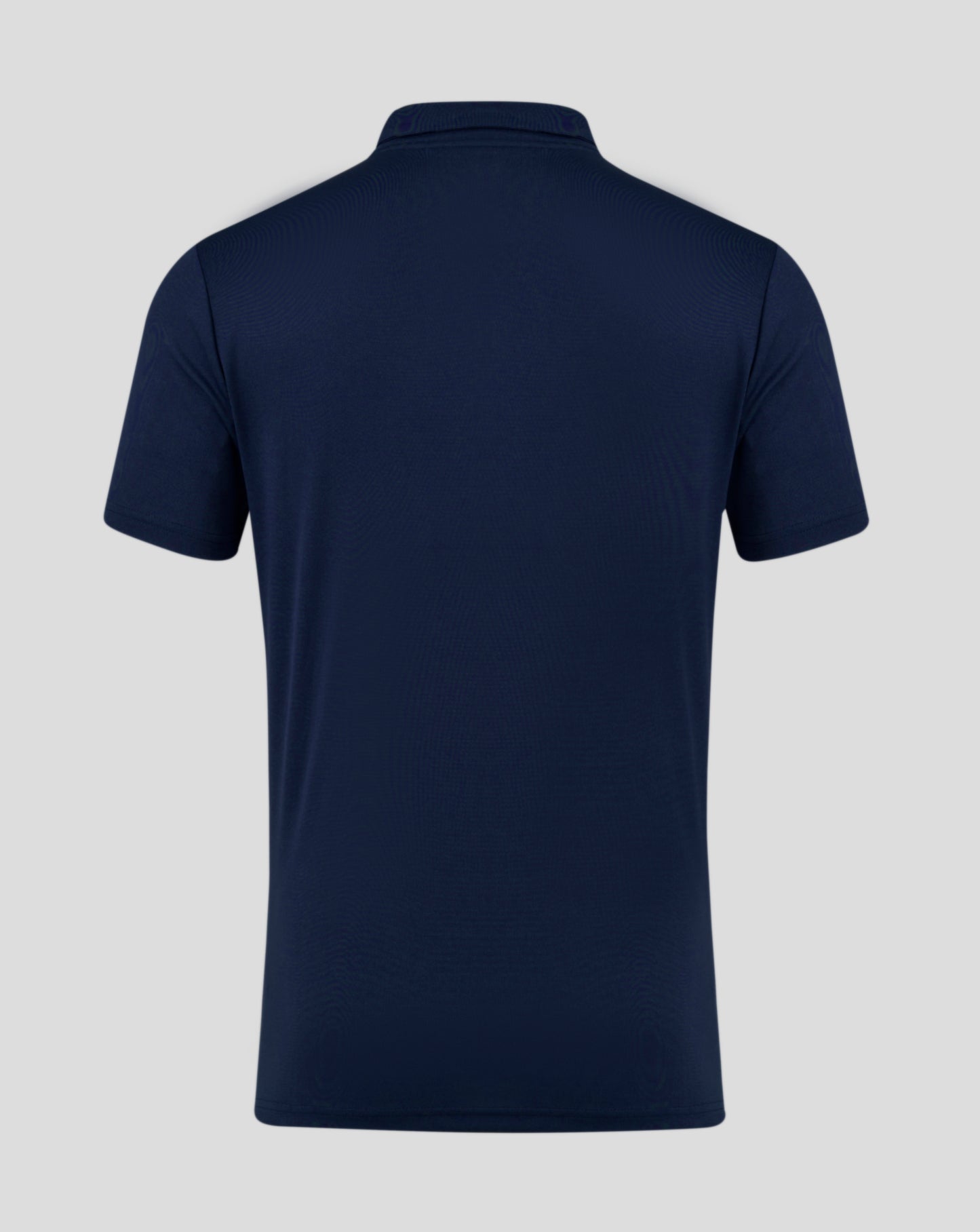 Back view of navy Peacoat men's performance polo with self fabric collar and heat sealed Castore logo at neckline.