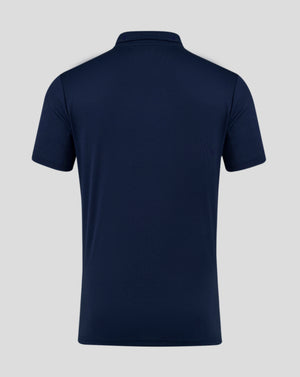 Back view of navy Peacoat men's performance polo with self fabric collar and heat sealed Castore logo at neckline.