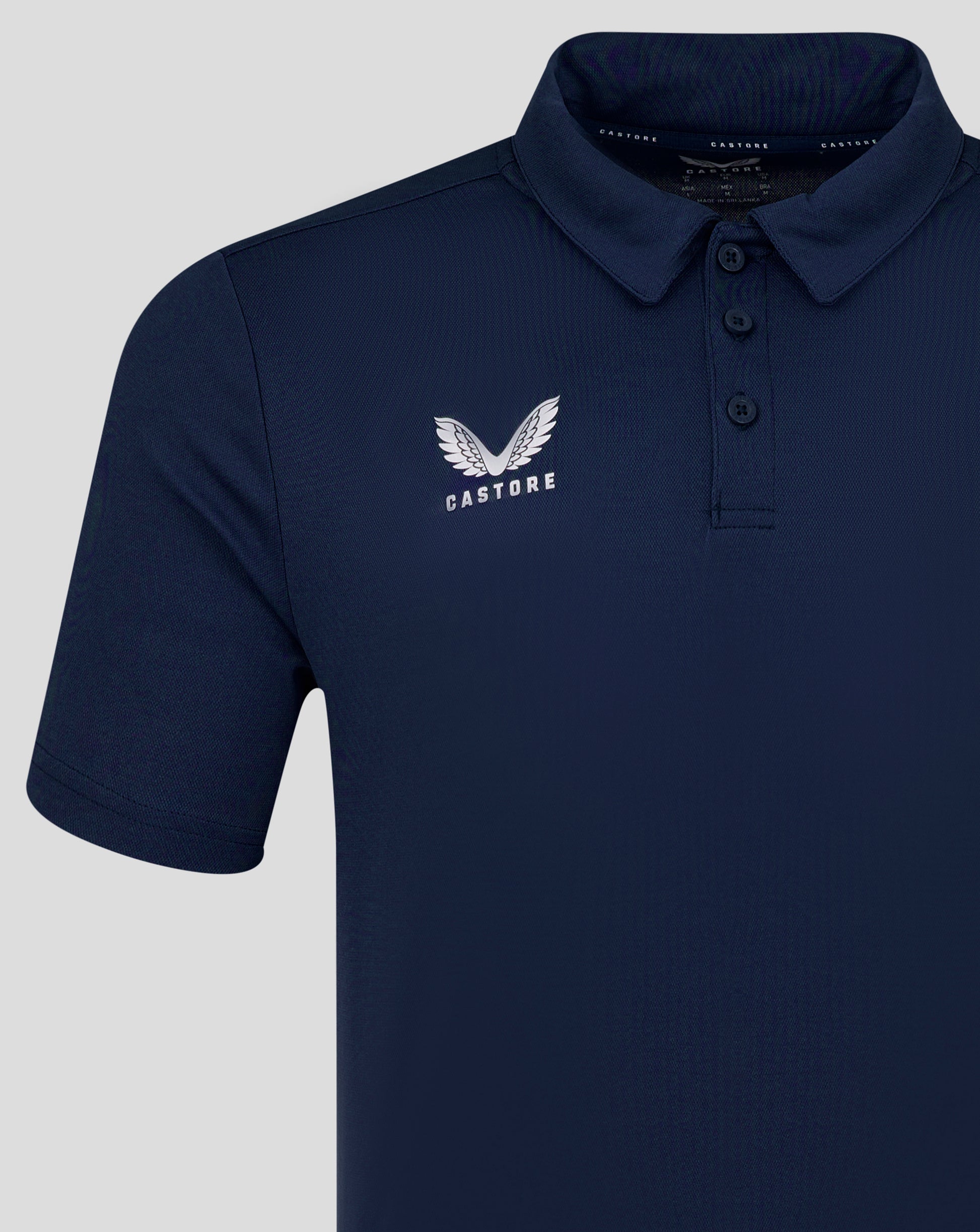 Front view of navy Peacoat men's performance polo with three button placket and left chest Castore logo.