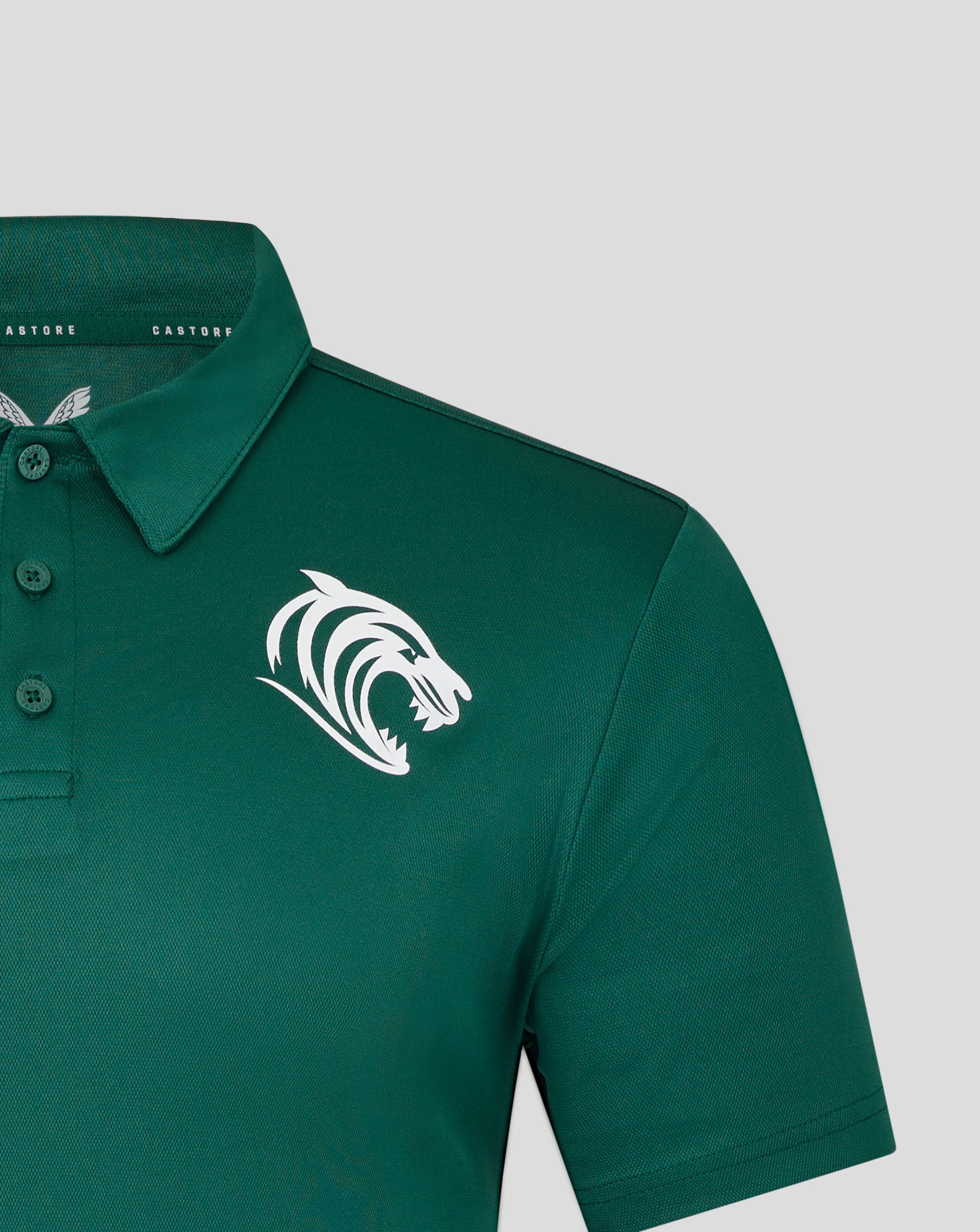 Front view of teal training polo with a prominent white tiger emblem on the chest