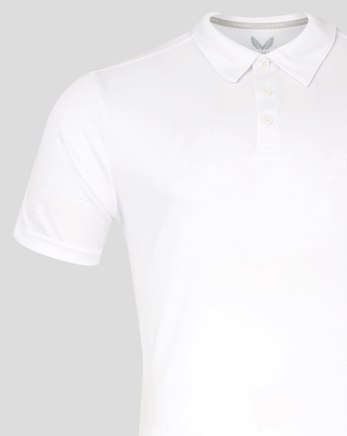 White men's performance polo with self fabric collar three button placket forward shoulder seam and heat sealed Castore logo