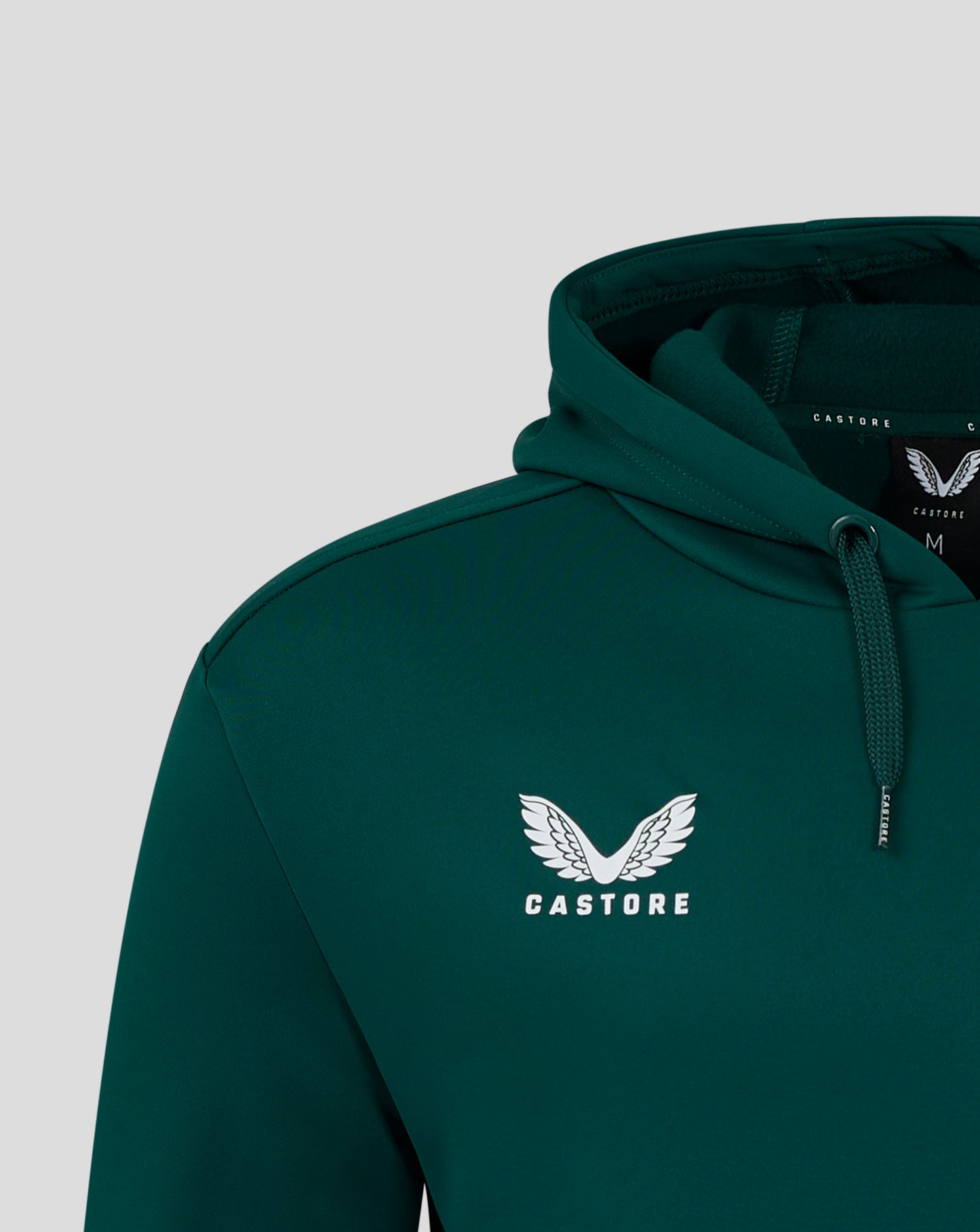 Close up of a green hoodie hood showing the interior lining and drawstrings.
