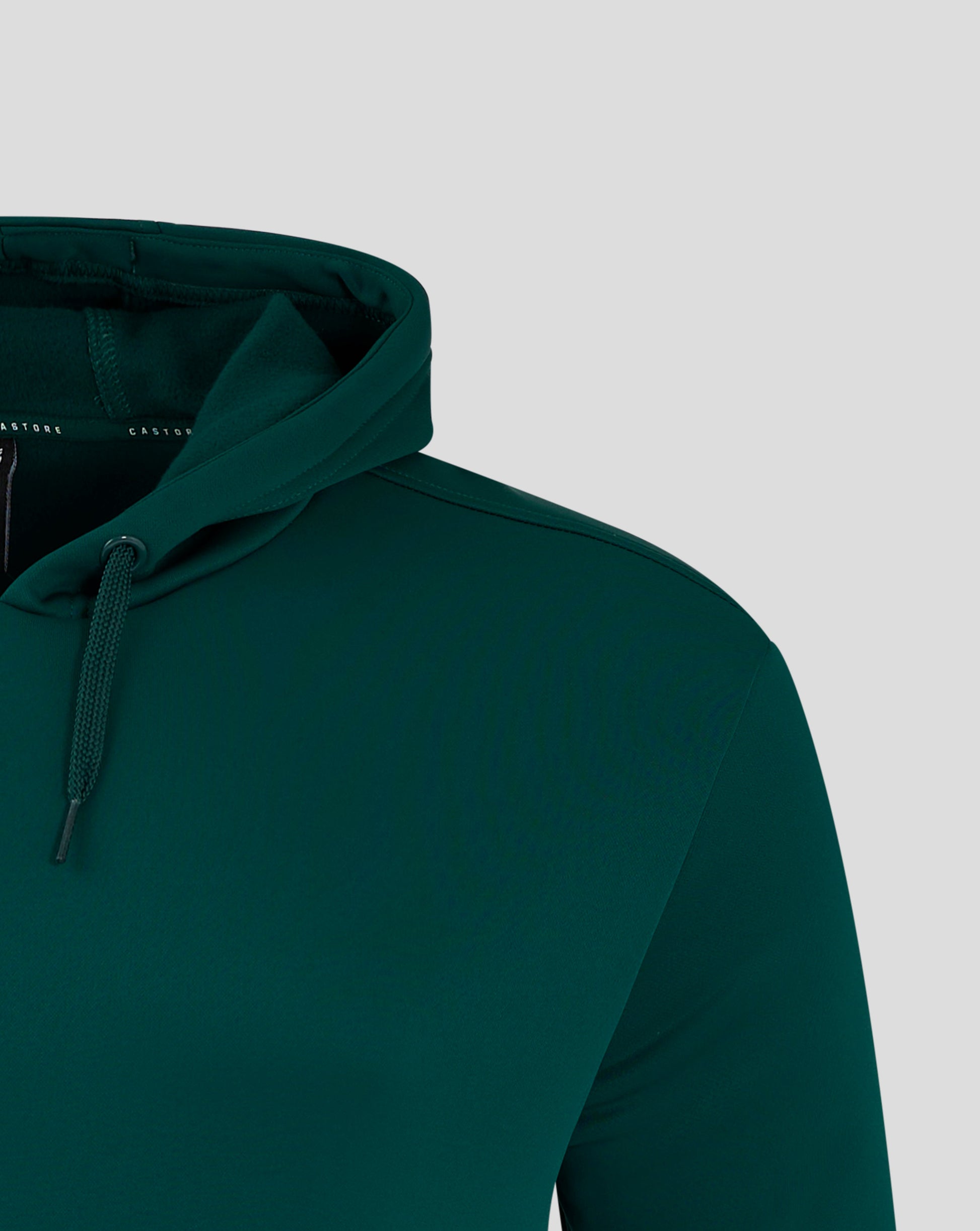 Shoulder and chest area of the green hoodie with a white wing logo on the chest.
