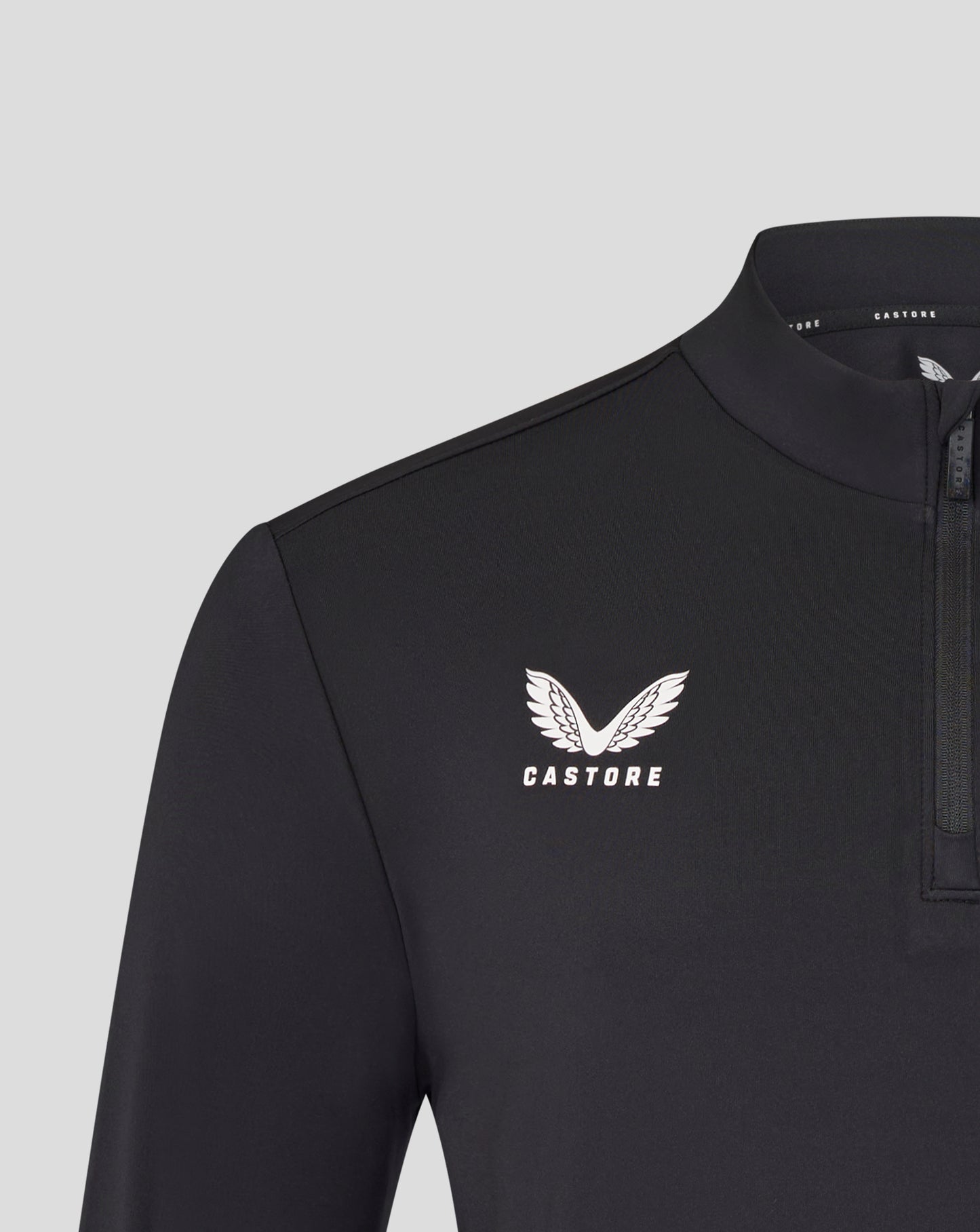 Chest shot of the black Leicester Tigers training midlayer featuring a white tiger crest and Castore branding