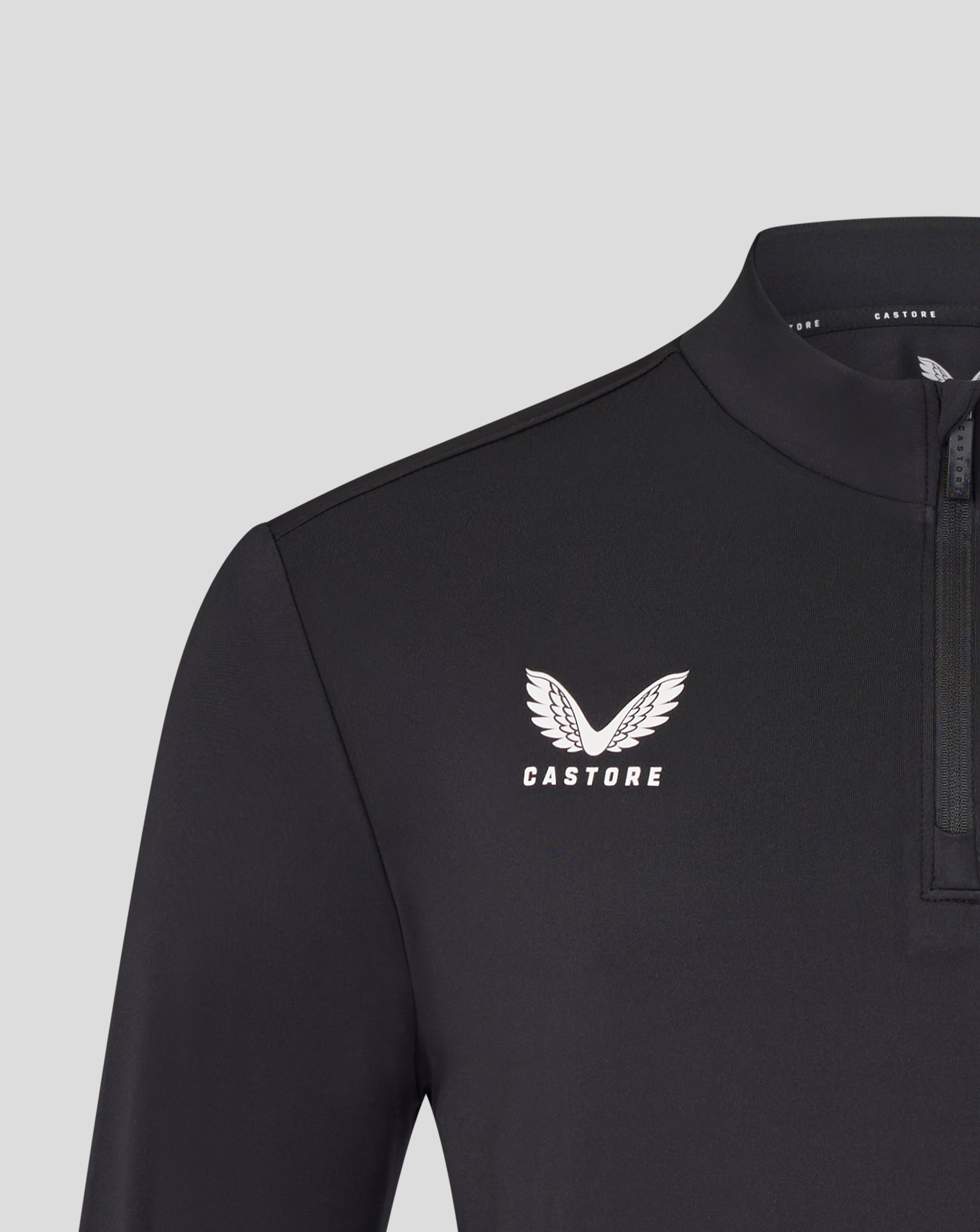 Chest shot of the black Leicester Tigers training midlayer featuring a white tiger crest and Castore branding