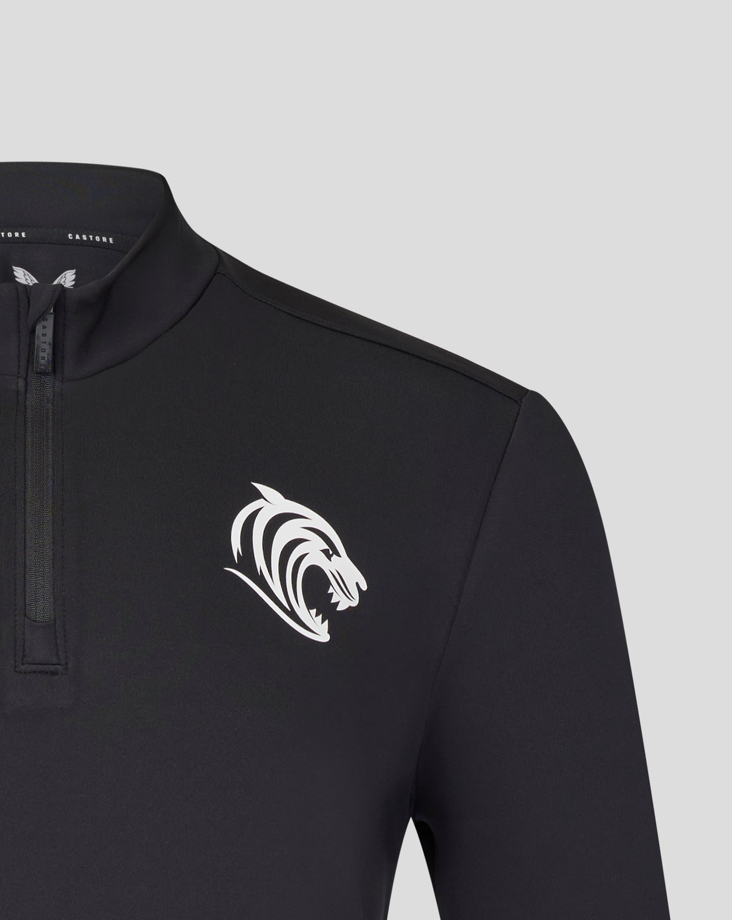 Close up of collar and zipper on a black Leicester Tigers training midlayer with a white tiger chest emblem