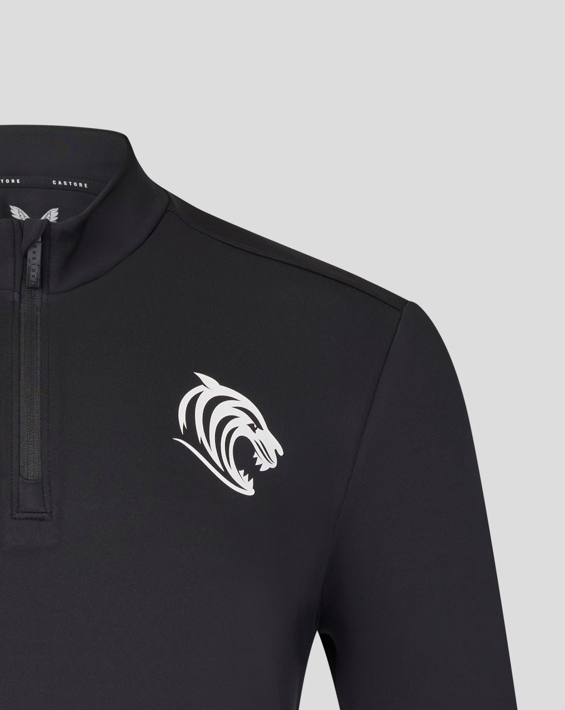 Close up of collar and zipper on a black Leicester Tigers training midlayer with a white tiger chest emblem