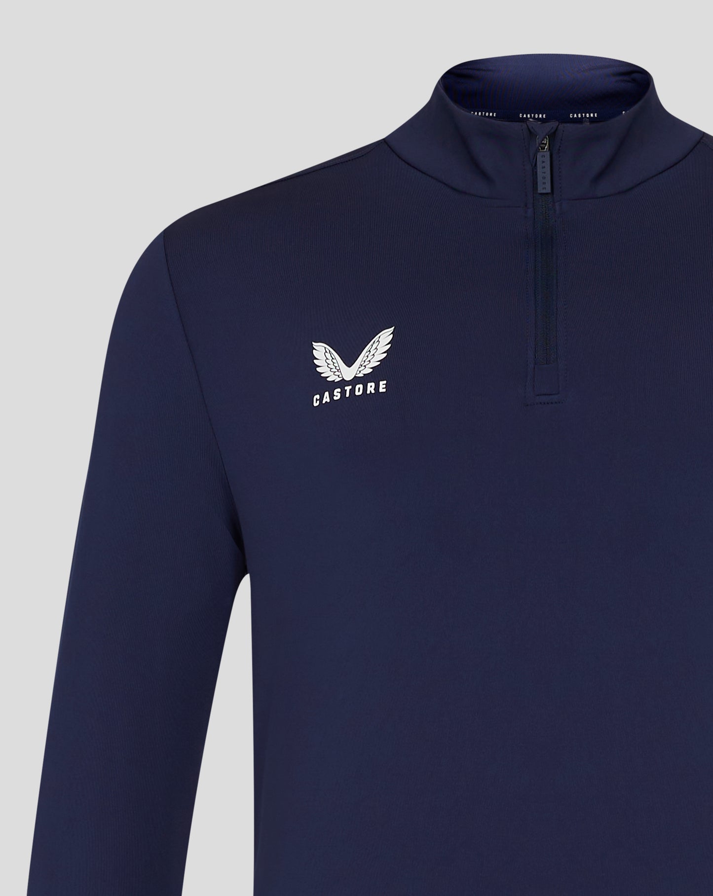 Front angled view of navy quarter zip top showing left chest Castore logo