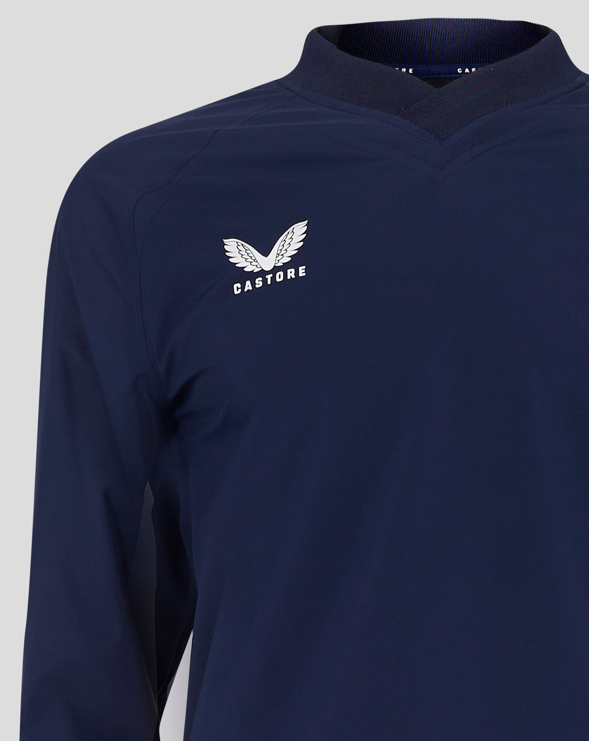 Back close-up of navy rugby top neck and shoulder area showing ribbed collar and stitching