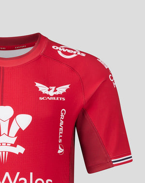 Close up of Scarlets Home Pro Shirt shoulder area showing red fabric, club crest on the chest and Owens branding on the sleeve