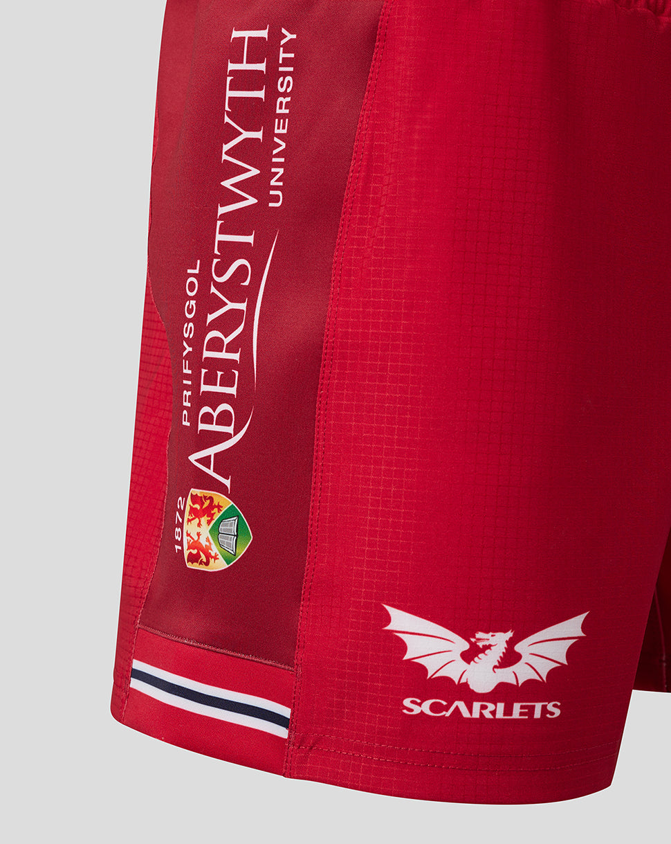 Side view of Scarlets Junior 23/24 Home Shorts showing a printed vertical side panel on red fabric