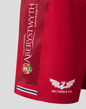 Side view of Scarlets Junior 23/24 Home Shorts showing a printed vertical side panel on red fabric