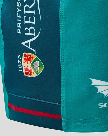 Close up of teal Scarlets away shorts side panel showing crest and 1872 patch with sponsor graphics